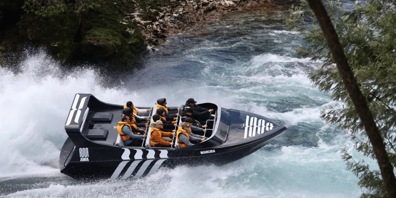 Rapids Jet boat leaning into a turn through whitewater