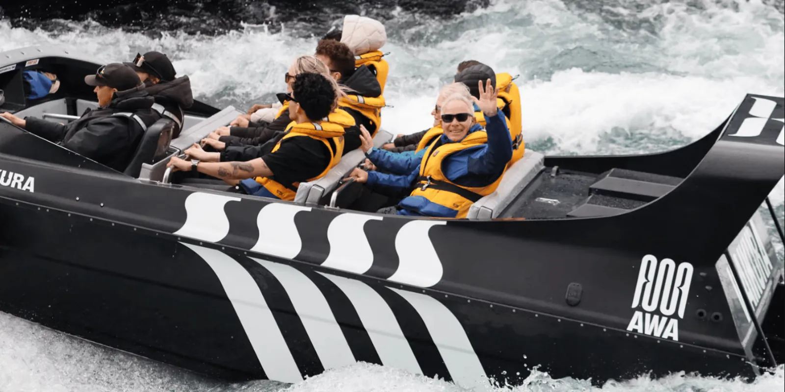 Passengers wearing yellow life jackets on Rapids Jet
