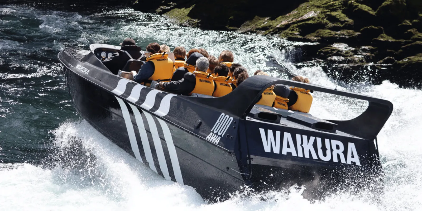 The Waikura jet boat riding through foaming river rapids