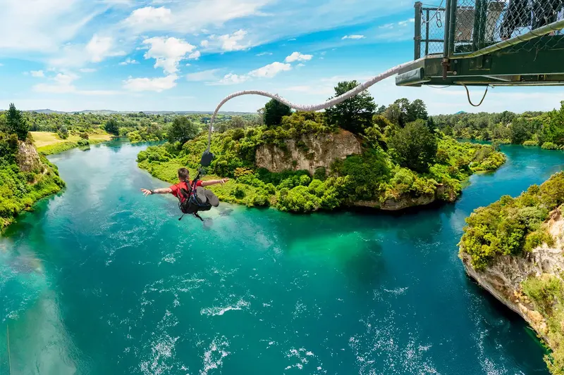 Solo bungy jumper above the turquoise Waikato River