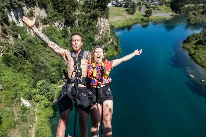 Two harnessed participants sharing the Taupō adventure